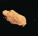 The asteroid Ida (B), photographed by Galileo, is 56 km in length and has its own moon, Dactyl.