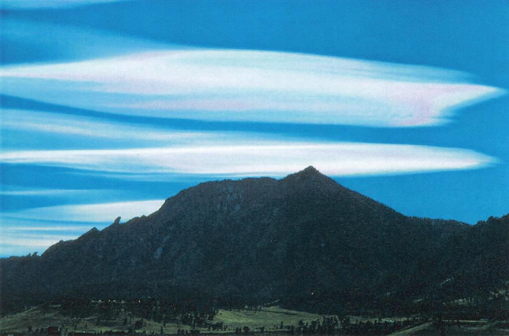 Fig. 1. Photograph of iridescent standing lenticular wave clouds above Boulder, Colorado, on 8 November 1995.