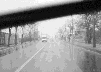 Indeed, the scene can be seen through the raindrop but the visual effect produced will strongly depend on the position of the camera regarding the windscreen.