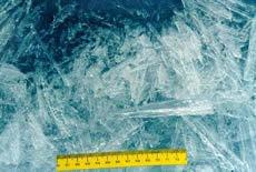 Top: Frazil ice, small needle-like ice crystals, typically 3 to 4 millimeters in