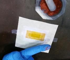 These samples will not be folded: Place a piece of Kapton tape with the sticky side up on the table (better on a piece of weighing paper to reduce contamination by other compounds) and tape it down