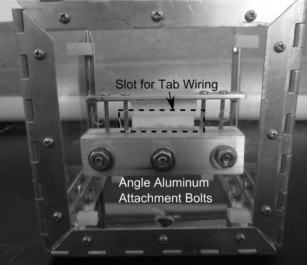 As the tab prototype was aligned horizontally, the laser was positioned above, requiring the top panel to be open during testing. Two images of the tab clamped are in figure 4.10.