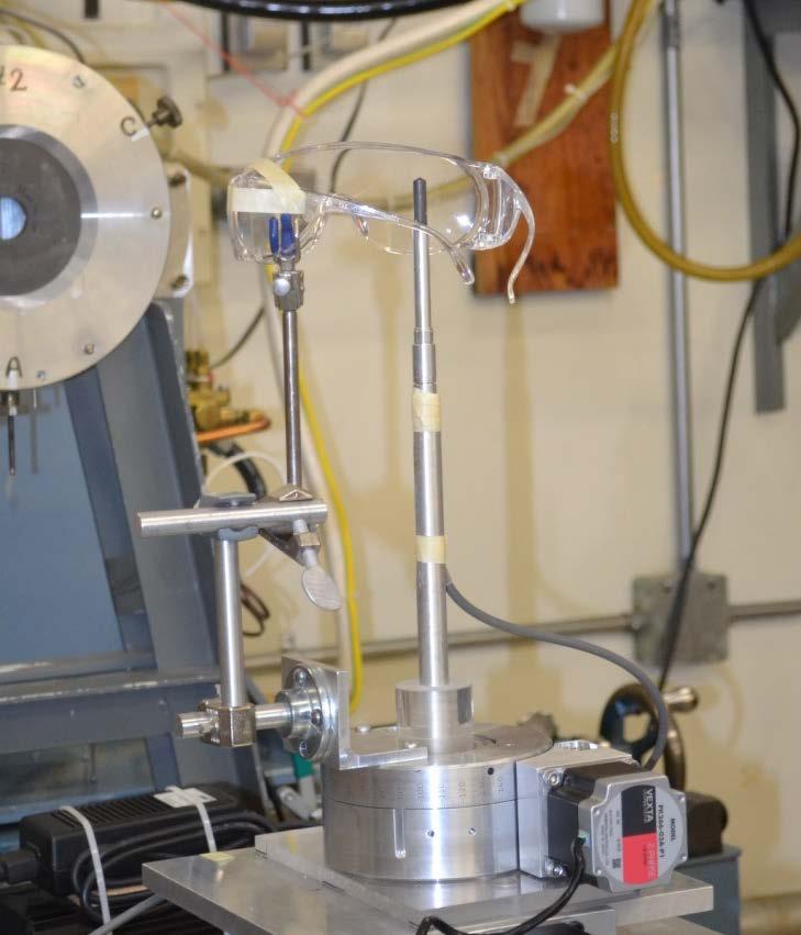 The photograph shows multiple sheets of 1 mm thick CR-39 sheets positioned between the ionization chamber and the x-ray tube. Figure 3 (right). Experimental set up for eyewear testing in x-ray beam.