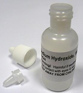 c. Place the tip to side of the bottle, leaving the bottle of NaOH open at the top. See Figure 6. Figure 6. Sodium hydroxide with dropper tip removed from bottle. 13.
