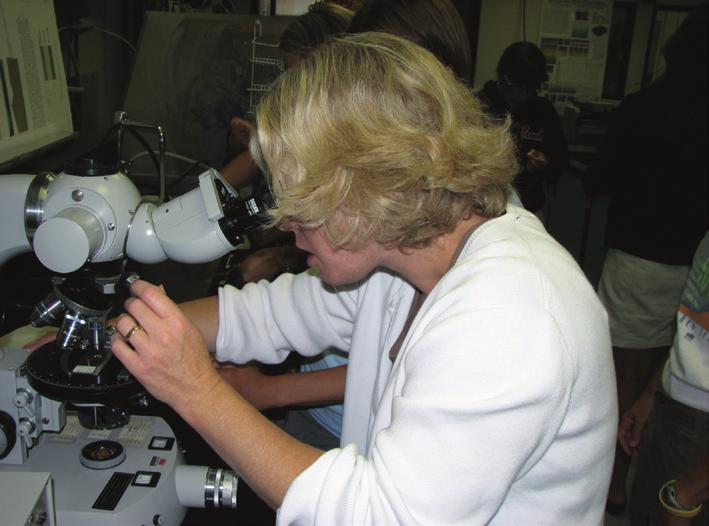 FIGURE 3.6. Geoscientist using a transmitted light microscope to examine microfossils and sediment on a smear slide. Photo courtesy of Mark Leckie.