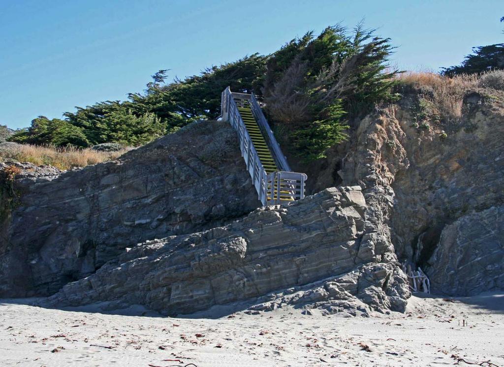 Stengel Beach Access Steps and shale Photo: access steps to Stengel Beach (near post 24) The access steps to Stengel Beach terminate on the top of a sandstone bed that is tilted to the north and you