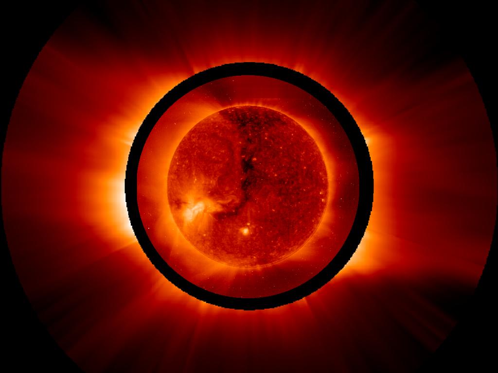 The Sun's outer atmosphere as it appears in ultraviolet light emitted by ionized oxygen flowing away from the Sun to form the solar wind (region outside black circle), and the disk of the Sun in