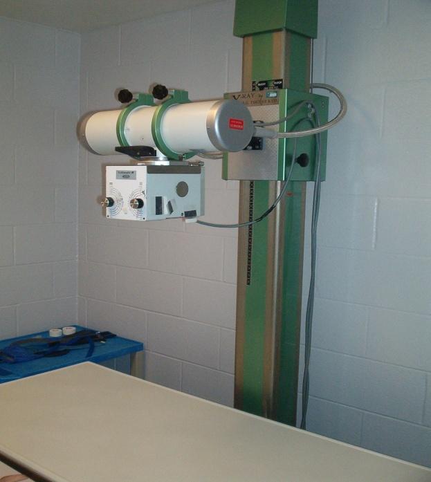 This picture X-ray tube in a collimated lead housing. The X-ray beam is pointed down to the table.