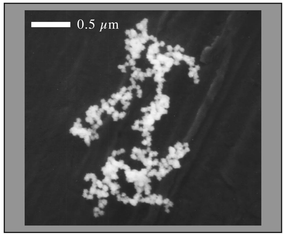 The duration of a growth cycle varies with the target material; see Table I. FIG. 6. Electron micrograph of particles grown from sputtering a carbon target. The particles have a bumpy spherical shape.
