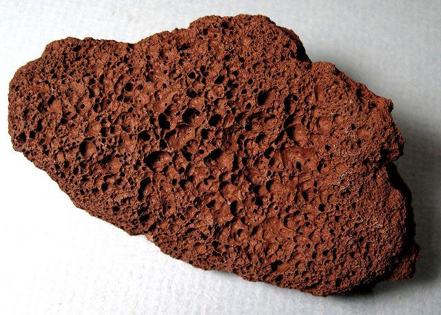 Pumice or scoria (darker) form when gas bubbles are in rapidly cooling