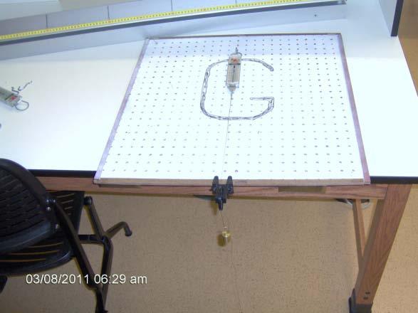 Attach a pegboard hook and spring gauge on the pegboard and using string tied to the spring gauge, hang a 200 gram mass to the other end of the string such that the string is over the pulley and the