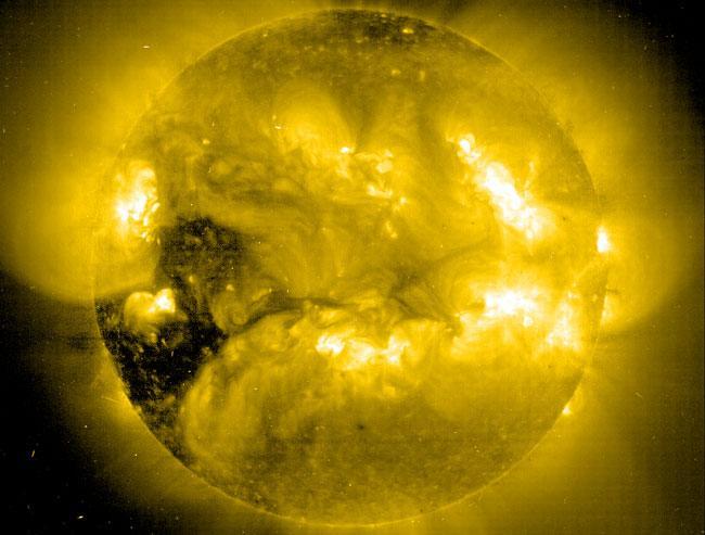 Dark Coronal Holes Emit Solar Wind