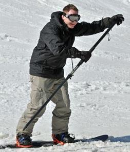 A force of 75N is required to push a 70 kg snowboarder along a flat trail with a