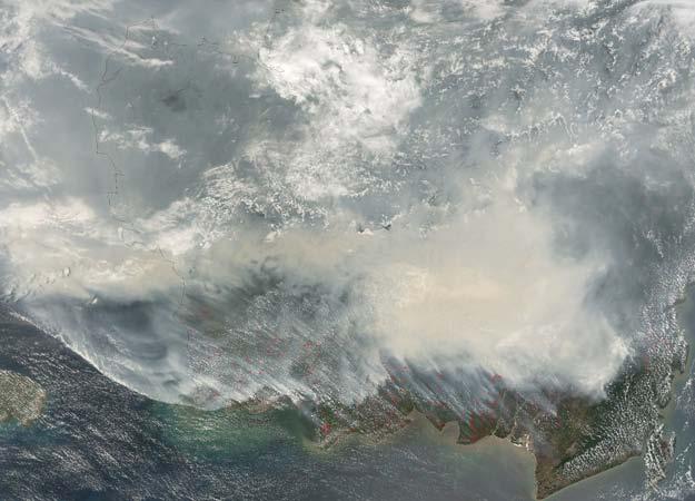 Biomass Burning Borneo Fires, Southeast Asia, 1997 Haze from automobile combustion and biomass burning, like this huge smoke plume over Borneo, may blot out the sun for a