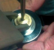 Use a wrench to tighten the part (clutch) as shown in the picture on the right to increase the amount of tension.