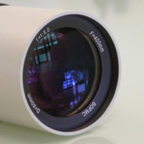 Stains on optics can be removed with optical cleaners used to clean photographic lenses.