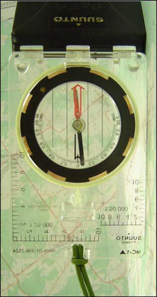 1. set the current declination on the compass; 2. set the compass dial to read 00 (zero) mils or 0 degrees (north); 3. lay the compass flat on the map with the cover open; a.