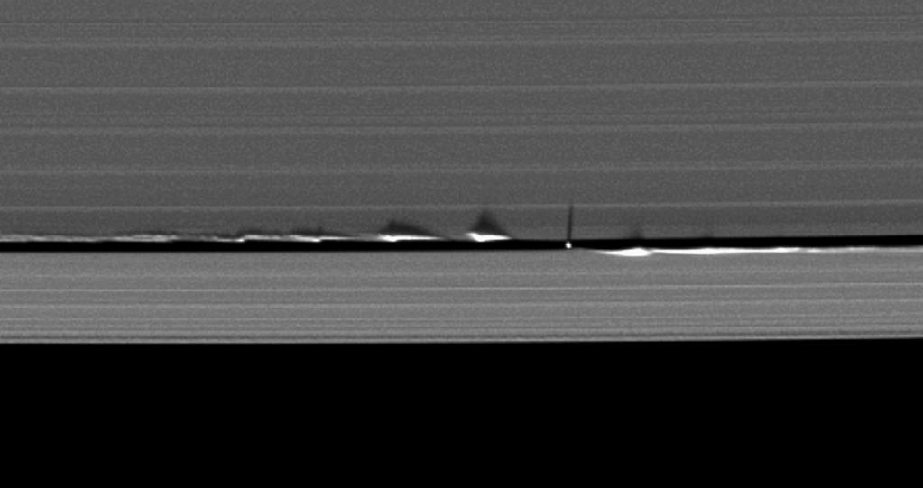 Fig. 27 Never-before-seen looming vertical structures created by the tiny moon Daphnis cast long shadows across the rings in this startling image taken as Saturn approaches its mid-august 2009