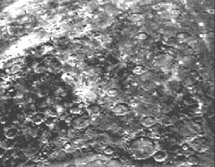 The lighter area on the left is part of the lunar highlands, while the dark region on the right is part of one of the maria.