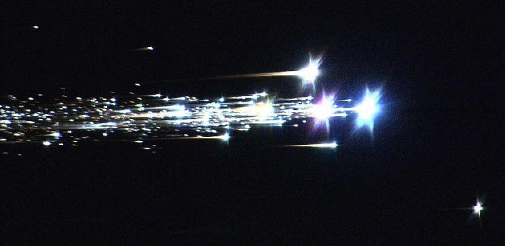 FIGURE 13.10 Hayabusa Return. This dramatic image shows the Hayabusa probe breaking up upon reentry.