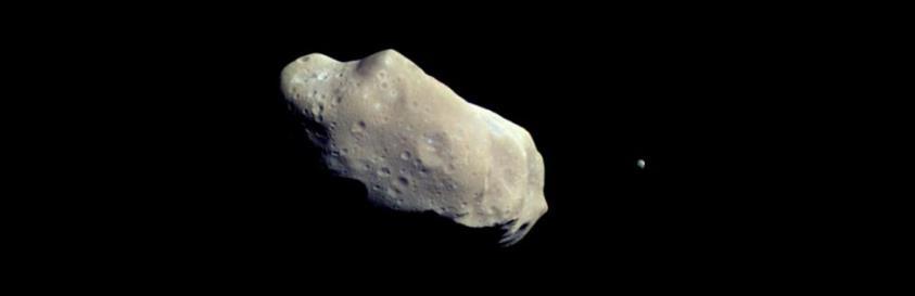 FIGURE 13.6 Ida and Dactyl. The asteroid Ida and its tiny moon Dactyl (the small body off to its right), were photographed by the Galileo spacecraft in 1993.