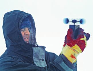 A scientist uses an anemometer in Antarctica. Wind speed is measured in miles per hour.