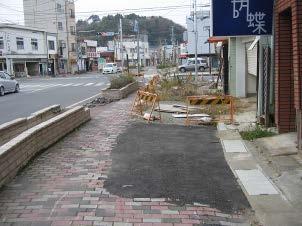 The ground around the interlocking block pavement was eroded by the tsunami where a utility pole was standing (Photo 22). Loosened blocks were carried away.