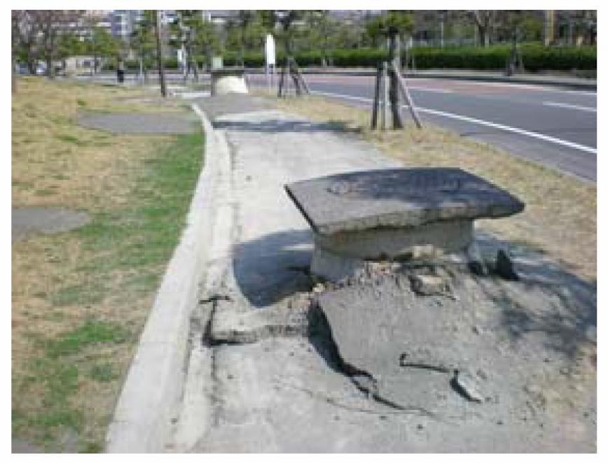 Figure 7: (a) (b) (a) Boiled sand on the road. (b) Lifted manhole.