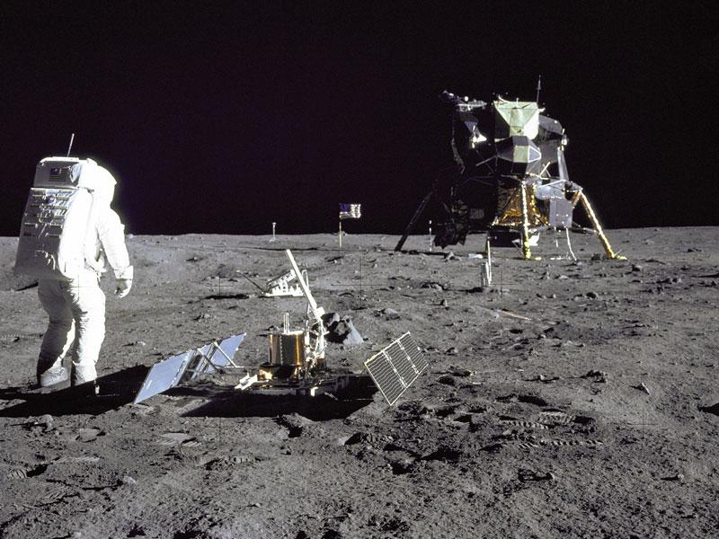 12 Buzz Aldrin placing lunar seismometer.