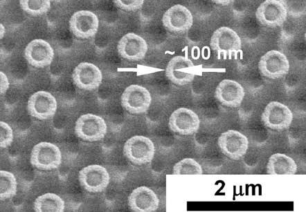Scanning electron micrographs (SEM) of microstructures in photoresist using different spherical microlenses embedded in