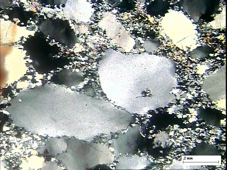 Overgrowth in quartz pebble in QPC from Brahmni River Section, West of Bagiyabahal. Quartz rich matrix.