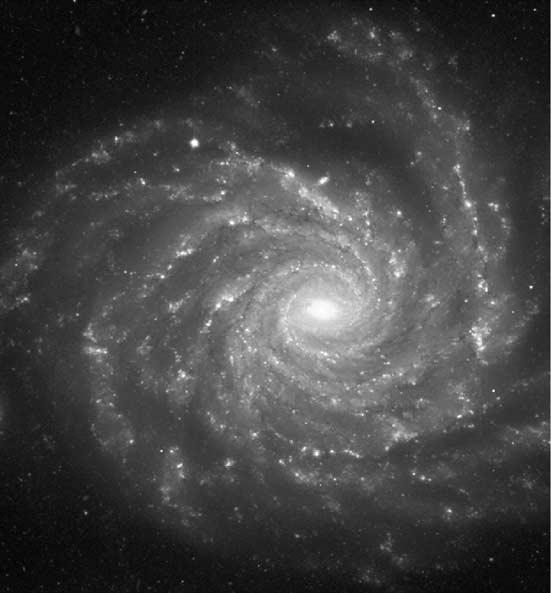 2 pluto figure 1.1 A face-on view of a spiral galaxy rather like ours. This has the galactic catalogue number NGC1232. (European Southern Observatory) also full of stars and interstellar matter.