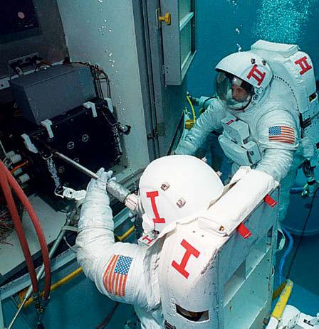 Astronauts float in space. So they practice working underwater before they take a space walk.