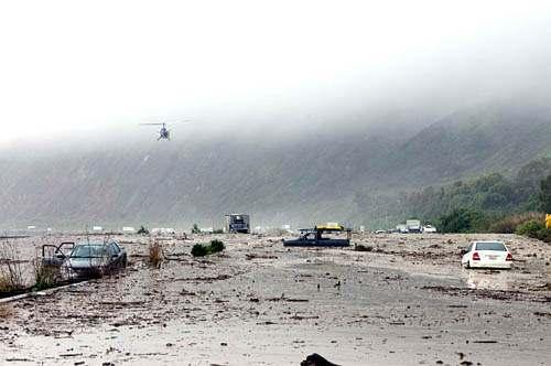 A helicopter surveys damage from a mudslide