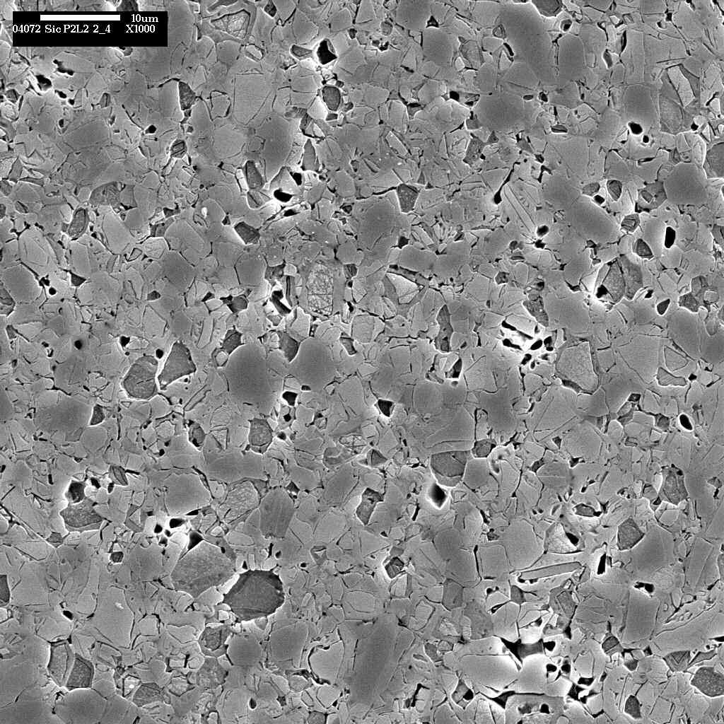 Figure 2. SEM micrograph of the polished and etched surface of a SiC-N specimen revealing grain boundaries and pore spaces (Micrograph by S. J. Glass).