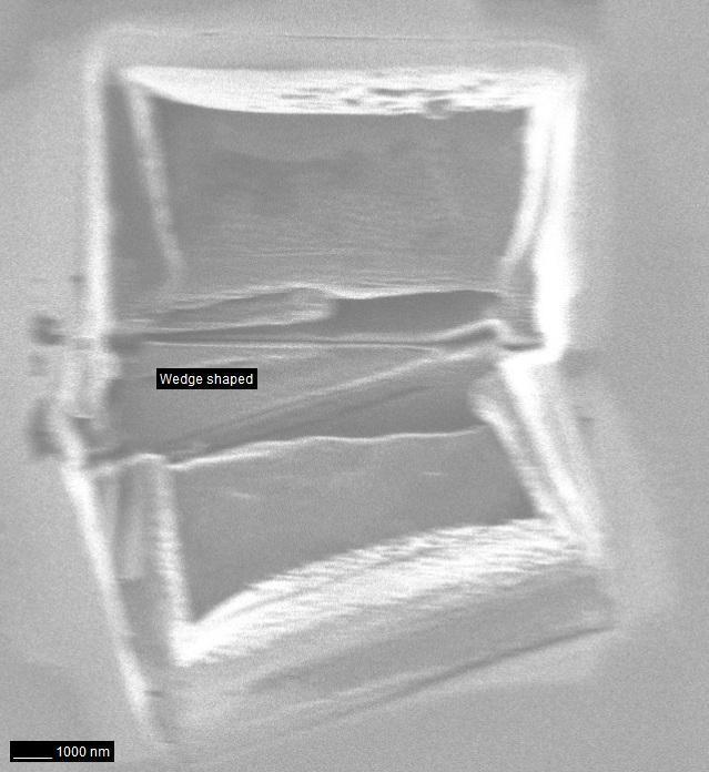 Figure 15: FIB micrograph of wedge shaped W (marked) showing the angle of the wedge shaped cut of γ = 20.6. Figure 16: HAADF-STEM micrograph of wedge shaped sample with a tungsten layer.