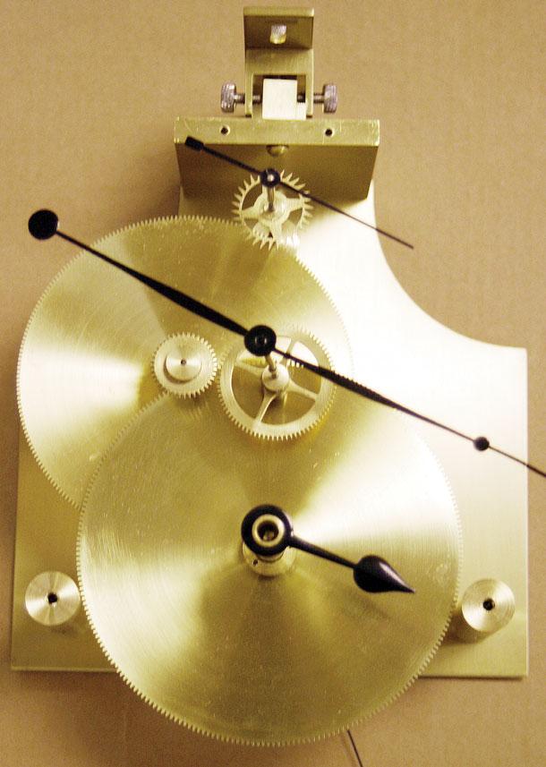 PETER G. SCHREINER. half-hour wheel turns counterclockwise, and the shaft extends through the plate and carries a wheel on the front of the plate.
