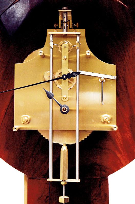 Figure 5, above. The escapement and top of the pendulum. Figure 6, right. Full view, the skeleton dial and mahogany case designed to show every detail of the construction. See front cover also.