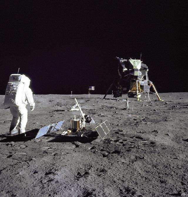 8. Figure 4 shows an Apollo astronaut on the surface of the Moon with the Apollo Lunar Surface Experiments Package (ALSEP) Figure 4 (source: NASA) (a) What was