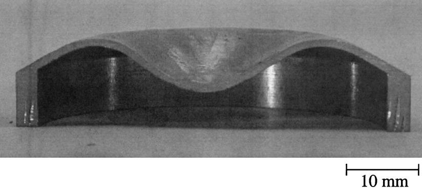 V.S. Deshpande, N.A. Fleck / J. Mech. Phys. Solids 51 (2003) 187 208 191 Fig. 3. Photograph of the! =30 (a =2:5 mm) conical frustum deformed to u 6 mm and section along its mid-plane.