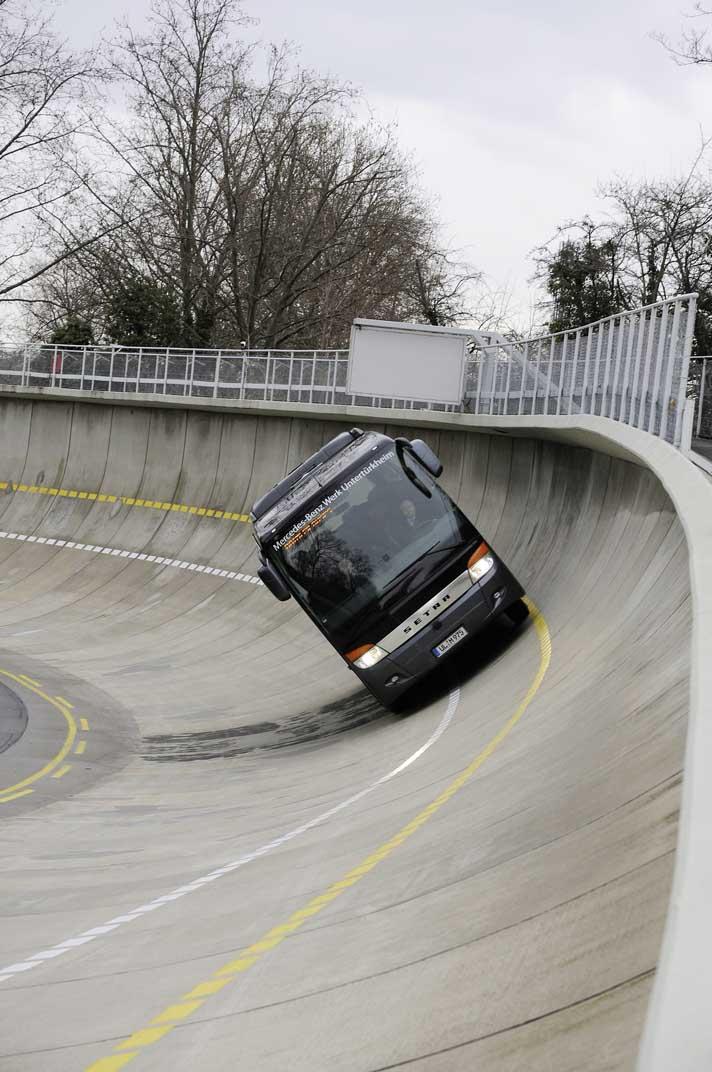 The photos above show two different views of a Setra S 411 HD bus cornering at high speed on the Mercedes- Benz test track at Untertürkheim, on the Neckar River