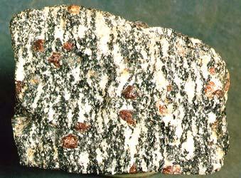 Metamorphic Rocks To recognize a metamorphic rock and distinguish it from an igneous or sedimentary rock two criteria are used: Metamorphic the group of minerals that form in a rock as a result of