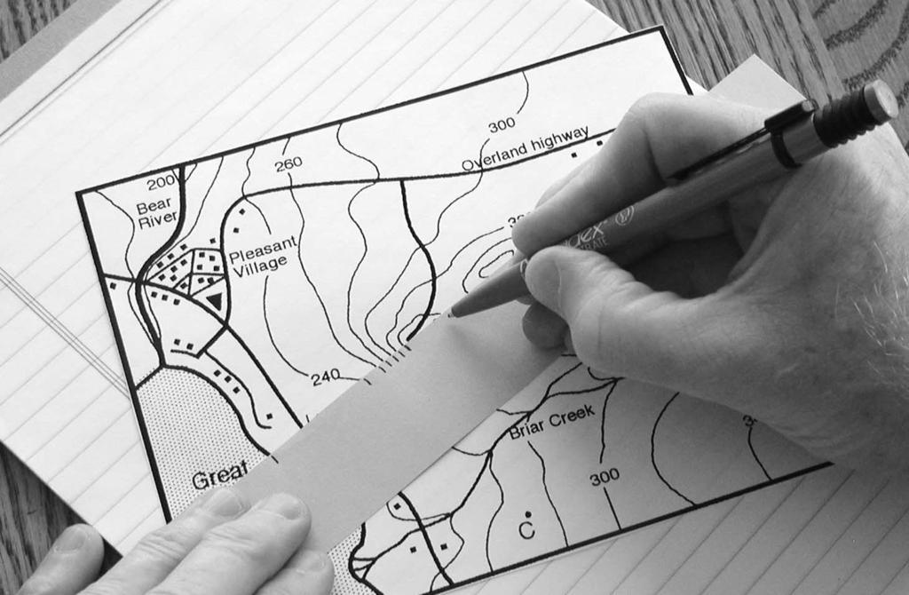 You will need a sheet of paper that is marked with parallel lines, such as writing paper, and a blank strip of paper a little longer than the profile route on the map.