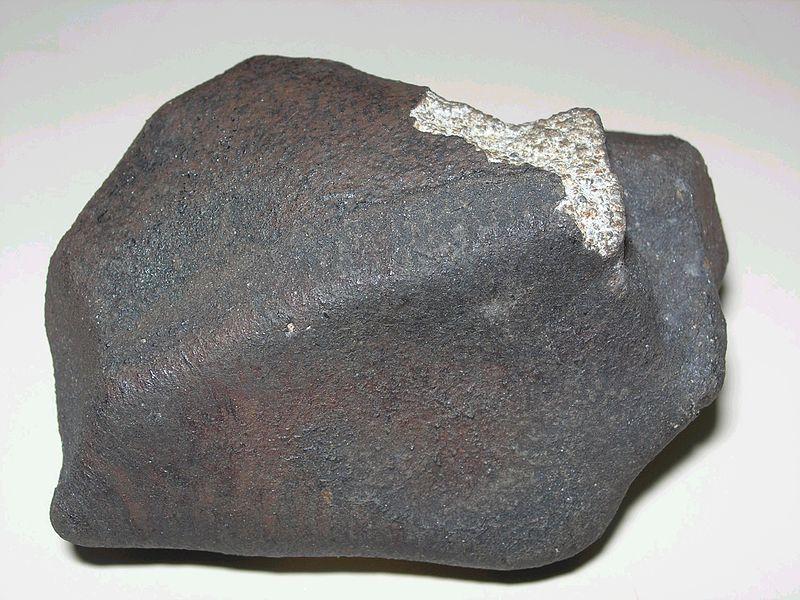 A stony meteorite Usually covered by a dark crust, created by