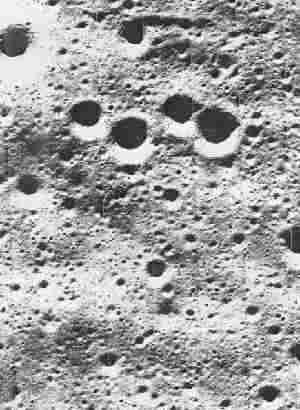 On the Moon, the floor of a typical crater is below the average level of the surface. The crater is surrounded by a raised rim.
