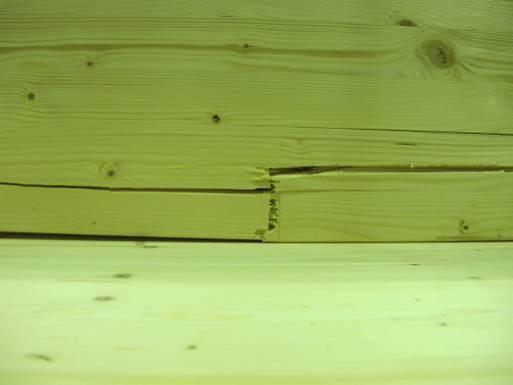Compression failure could be observed on the upper side of the glulam member between the points of load application for all test series, often down