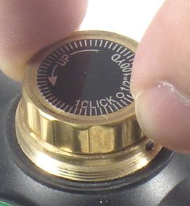 1. ZEROING - Unscrew and remove the cap of the adjustment knob. Put the cap away in a safe place. i. Zeroing with a Bore Sighter i a.