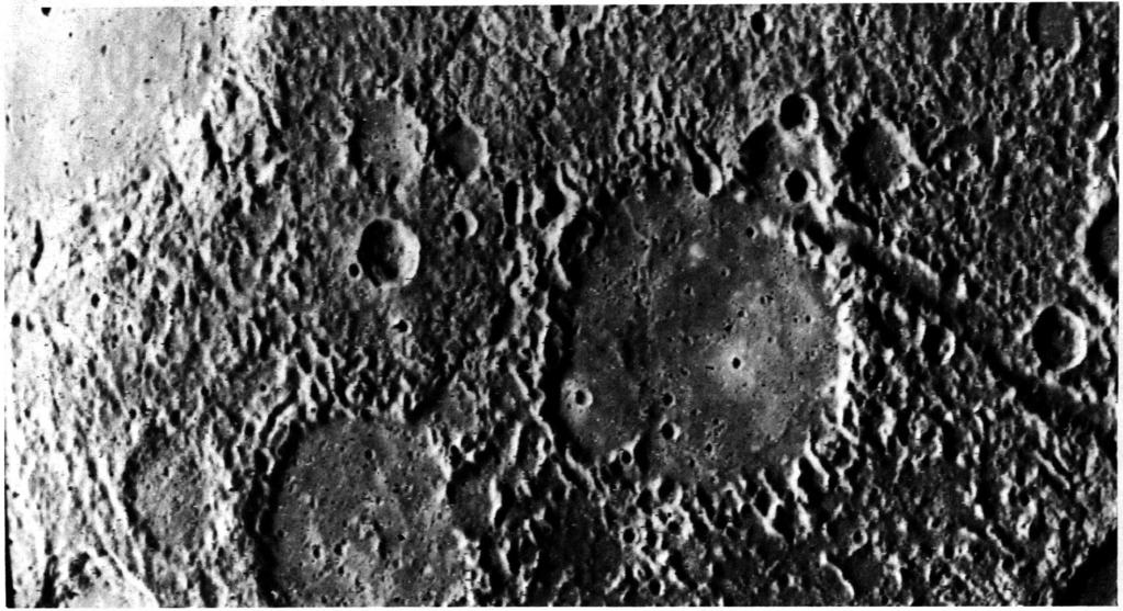 Numerous small craters and linear grooves radial to the crater probably are ejecta thrown from the crater by impact. The surface is illuminated from the left.