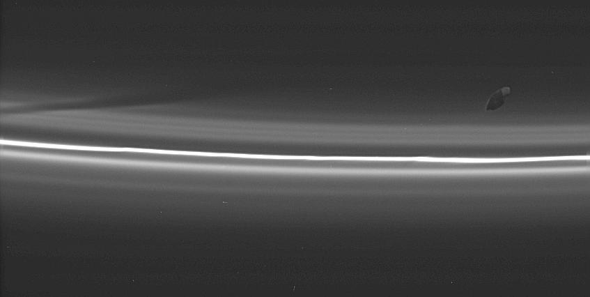 Saturn s moon Prometheus (63 miles across) is seen here making a new diagonal gore in the tenuous material inside Saturn s F ring.