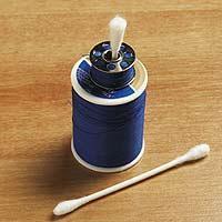 To keep a bobbin with its matching spool of thread, insert a cotton swab through the bobbin and into the top of the spool.